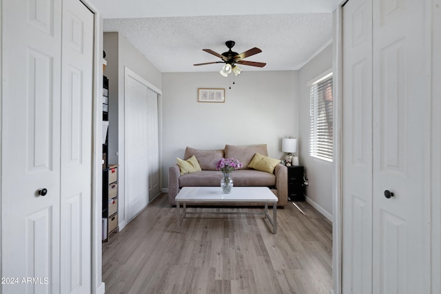 interior space with light hardwood / wood-style flooring, ceiling fan, and a textured ceiling