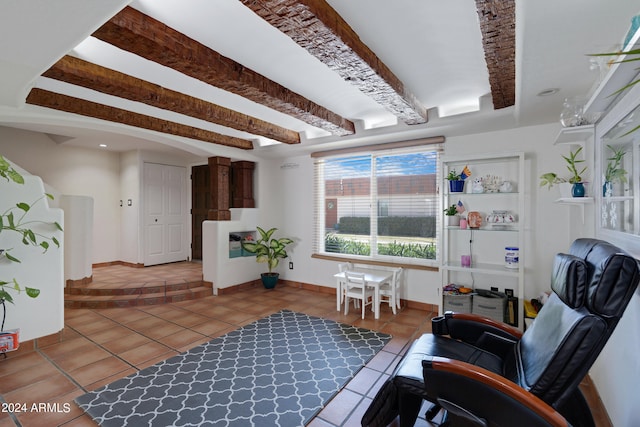 sitting room featuring beamed ceiling and tile floors