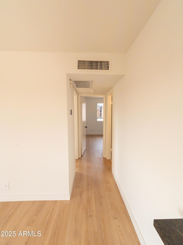 corridor with light wood-type flooring