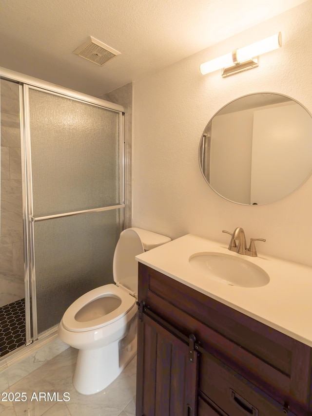 bathroom featuring vanity, toilet, and walk in shower