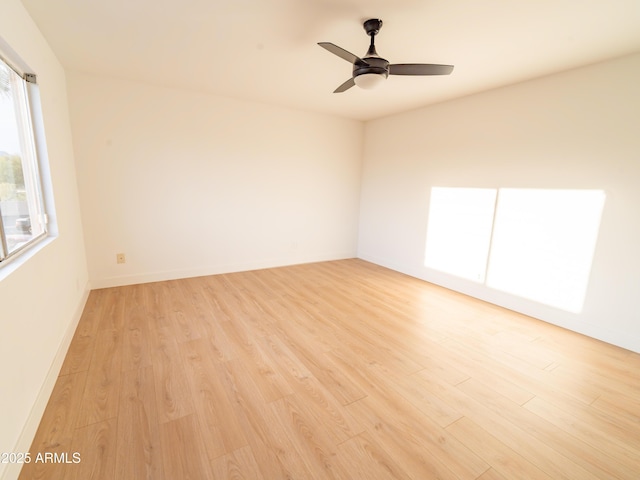 empty room with light hardwood / wood-style floors and ceiling fan