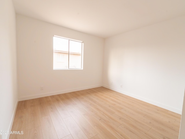 unfurnished room with light hardwood / wood-style floors