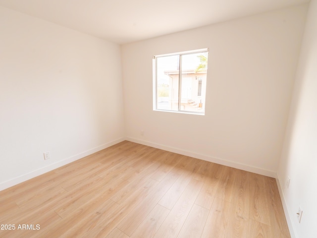 unfurnished room with light hardwood / wood-style floors