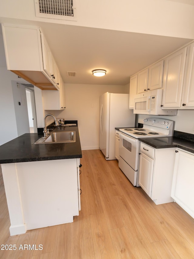 kitchen featuring sink, light hardwood / wood-style flooring, kitchen peninsula, white appliances, and white cabinets