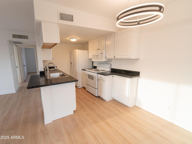 kitchen featuring sink, white cabinetry, decorative light fixtures, light wood-type flooring, and white appliances