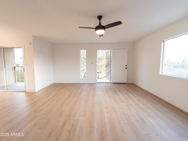 unfurnished room with ceiling fan and light wood-type flooring