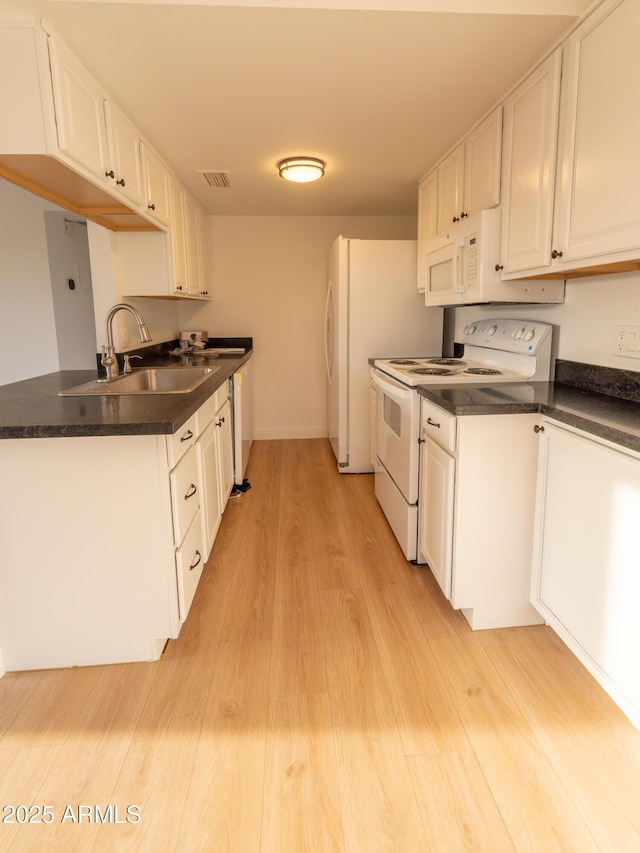 kitchen with white appliances, sink, light hardwood / wood-style flooring, and white cabinets