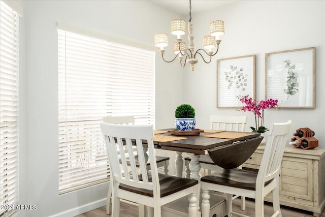 dining area featuring a chandelier, a healthy amount of sunlight, and hardwood / wood-style floors