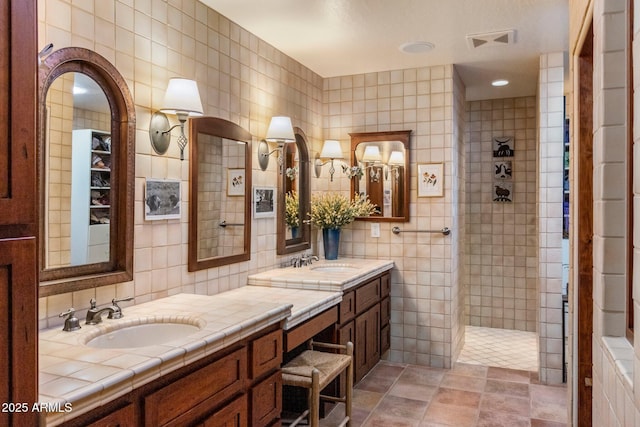 25002 N Quail Haven Dr, Rio Verde, AZ 85263 - bathroom featuring tile walls, double vanity, walk in shower, and decorative backsplash