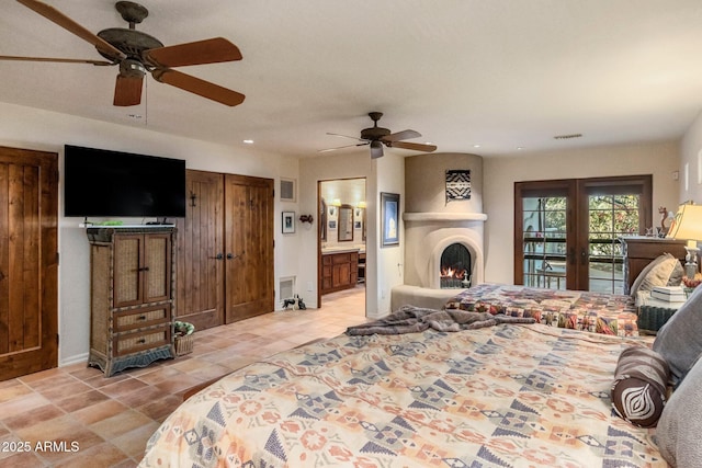 25002 N Quail Haven Dr, Rio Verde, AZ 85263 - bedroom with access to exterior, light tile patterned flooring, a warm lit fireplace, recessed lighting, and french doors