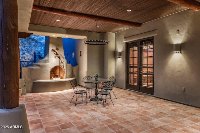25002 N Quail Haven Dr, Rio Verde, AZ 85263 - view of patio / terrace with a lit fireplace, french doors, and outdoor dining area