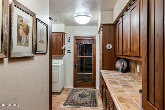 25002 N Quail Haven Dr, Rio Verde, AZ 85263 - washroom featuring cabinet space, washer / clothes dryer, and a textured ceiling