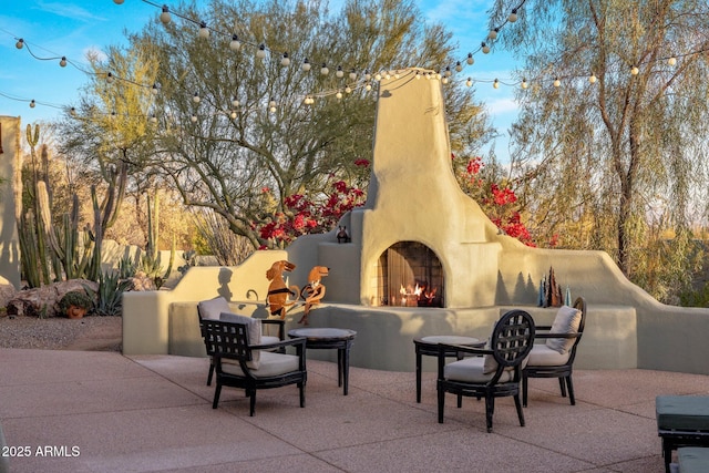 25002 N Quail Haven Dr, Rio Verde, AZ 85263 - view of patio / terrace featuring a lit fireplace
