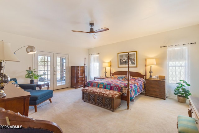 bedroom with multiple windows, carpet, and access to outside
