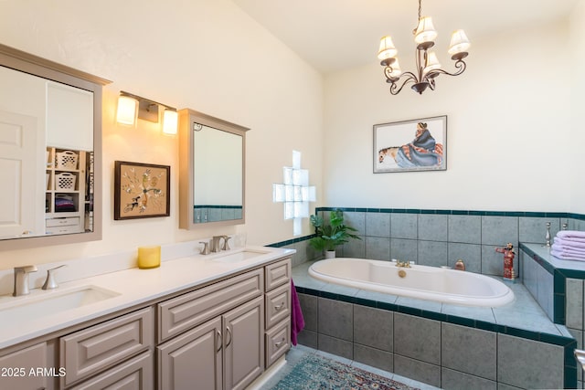 full bathroom featuring double vanity, a bath, a notable chandelier, and a sink
