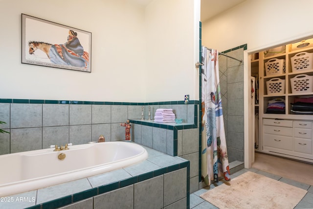 bathroom featuring tile patterned floors, a tile shower, and a bath