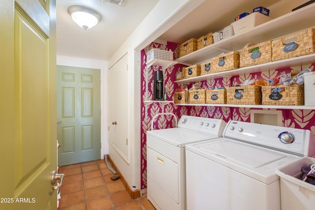 washroom featuring light tile patterned flooring, washing machine and dryer, and laundry area