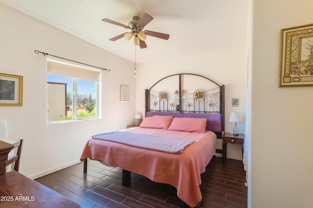 bedroom with baseboards, ceiling fan, and wood finish floors