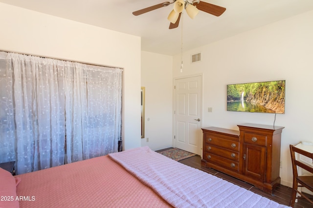 bedroom featuring visible vents, wood finished floors, and a ceiling fan