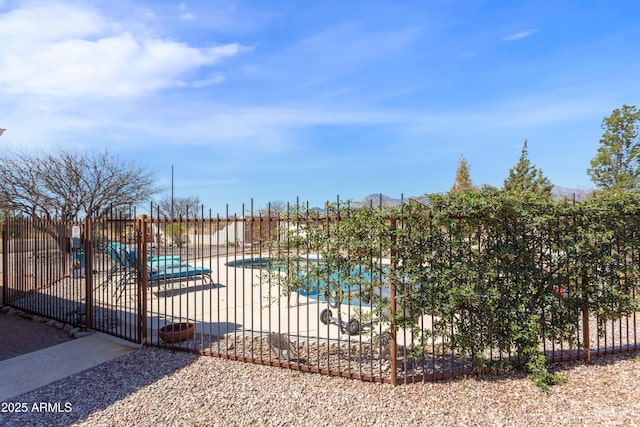 pool featuring fence and a patio area