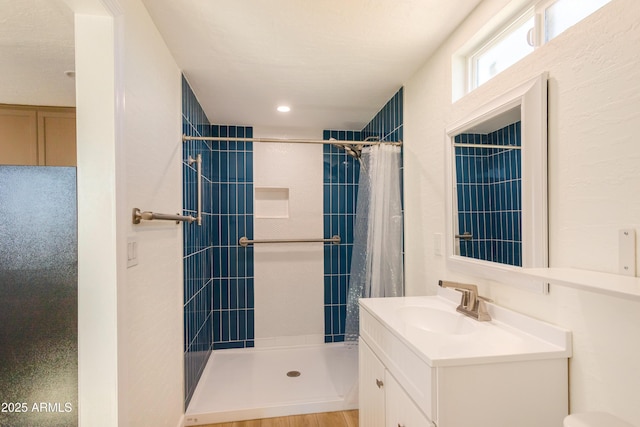 full bath with vanity and a tile shower