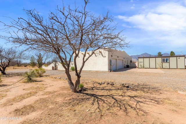 view of yard featuring driveway and an attached garage