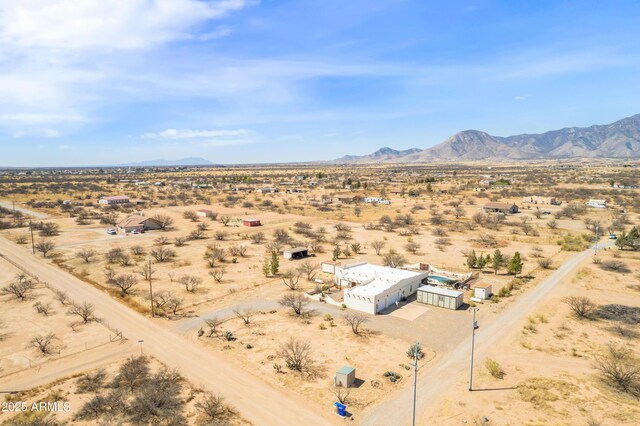 drone / aerial view with a mountain view, a rural view, and view of desert