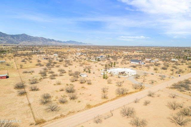 property view of mountains featuring view of desert and a rural view