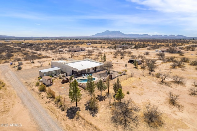 bird's eye view with a mountain view, a rural view, and view of desert