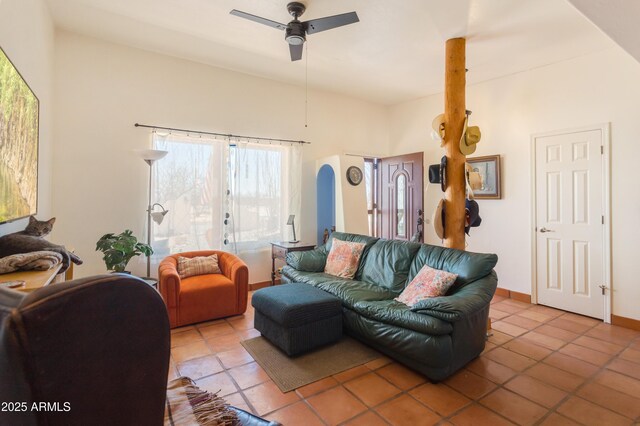 living room with light tile patterned flooring, baseboards, and a ceiling fan
