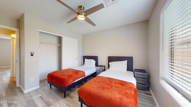 bedroom featuring light wood-type flooring, a closet, and ceiling fan