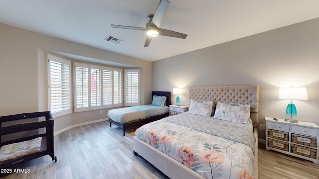 bedroom with ceiling fan and light hardwood / wood-style flooring