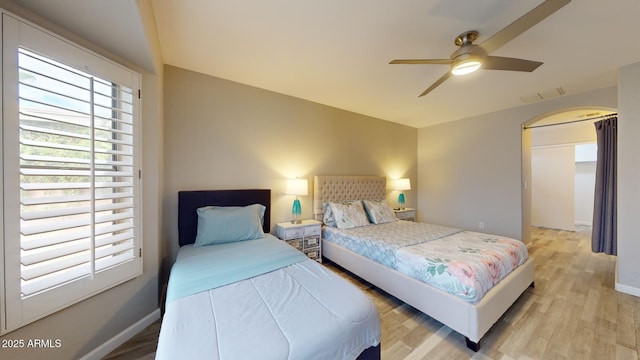 bedroom with light hardwood / wood-style floors and ceiling fan