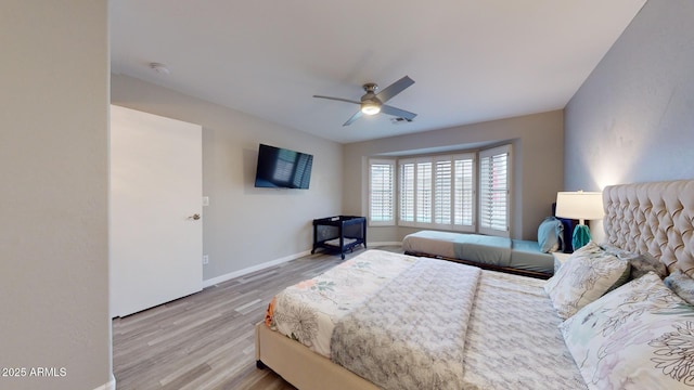 bedroom with ceiling fan and light hardwood / wood-style floors