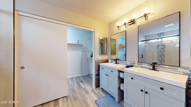 bathroom with vanity, an enclosed shower, and wood-type flooring