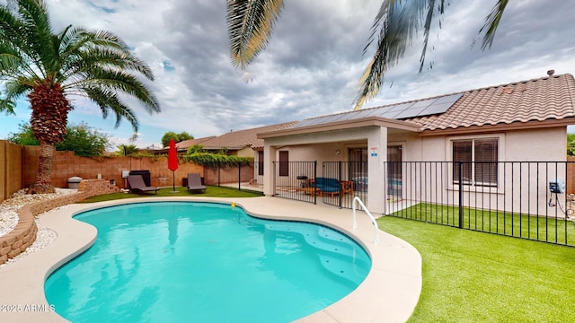 view of pool with a yard and a patio