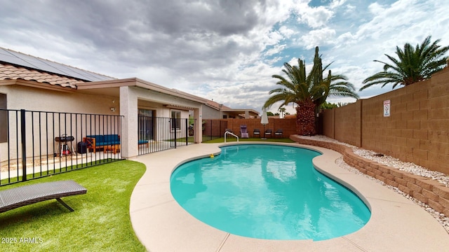 view of swimming pool featuring a lawn and a patio