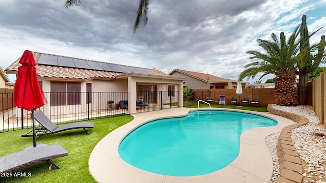 view of pool with a patio area and a yard