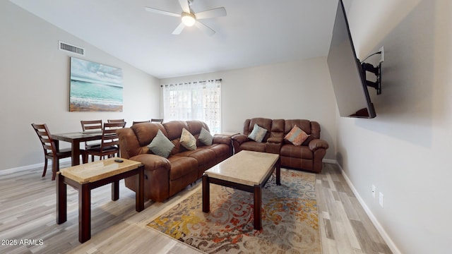 living room featuring ceiling fan, light wood-type flooring, and vaulted ceiling