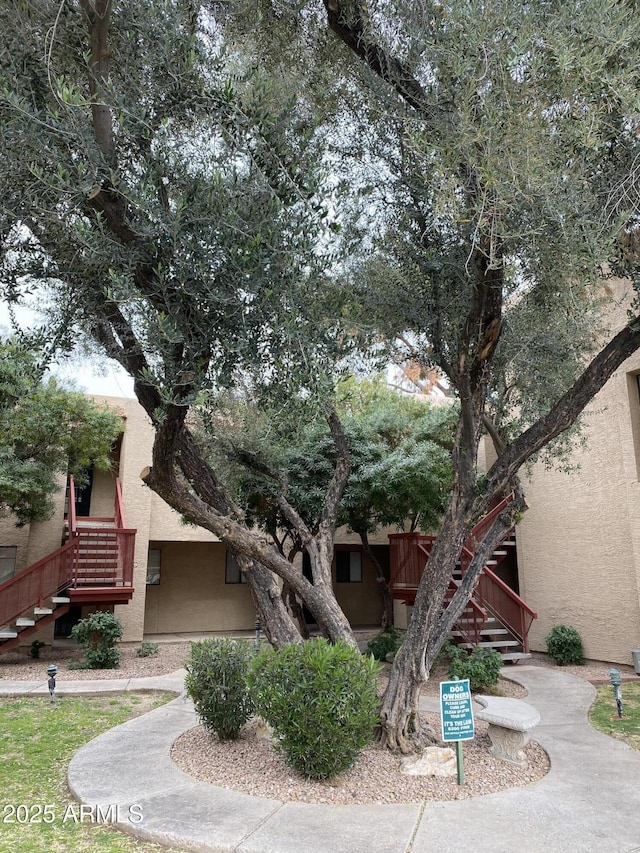 view of front of property featuring stairway and stucco siding