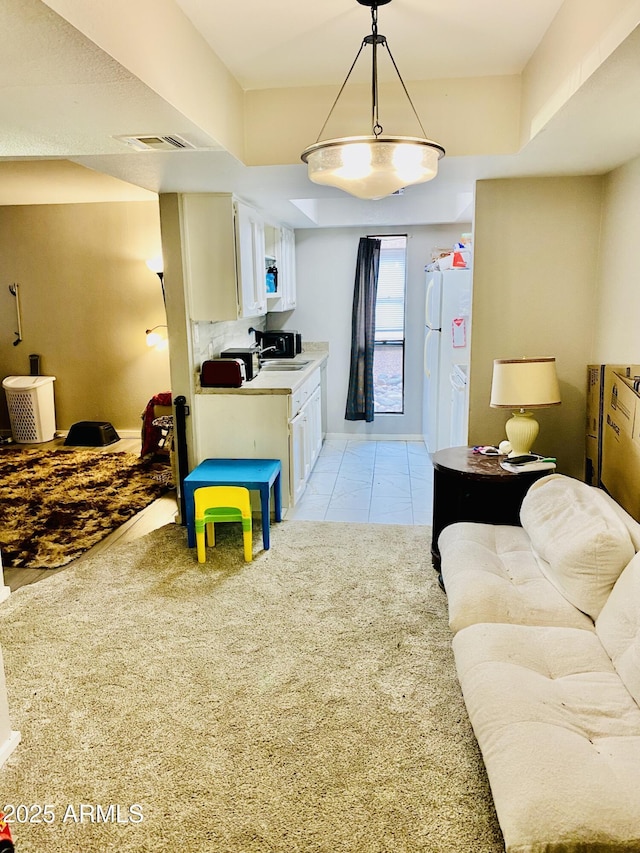 living area featuring light tile patterned floors and visible vents