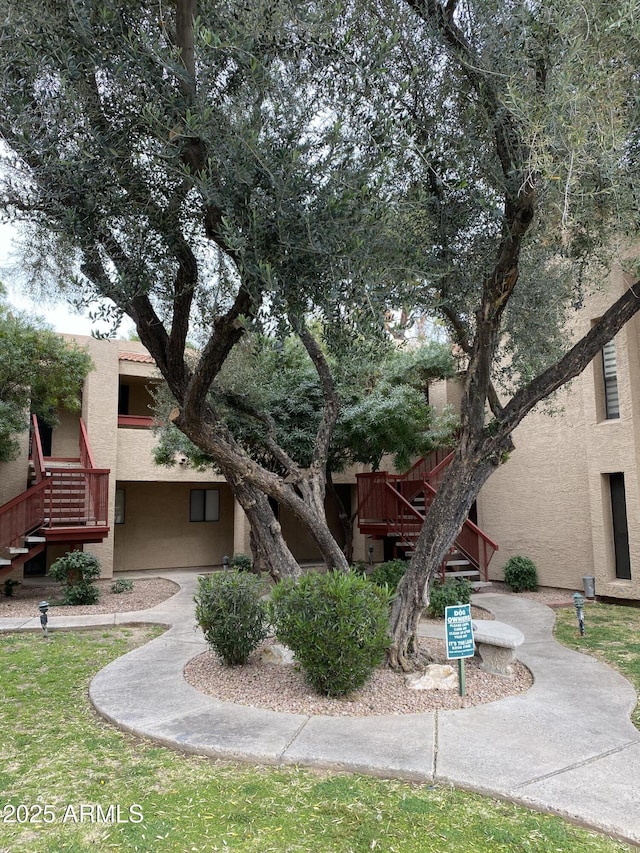 view of front of house with stairs and stucco siding