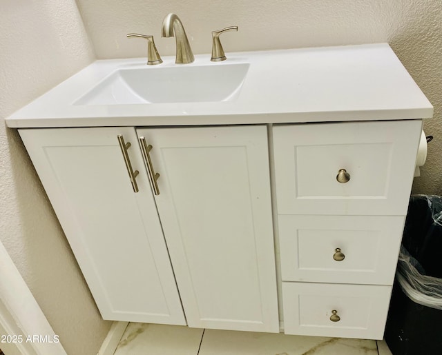 details with a sink and a textured wall