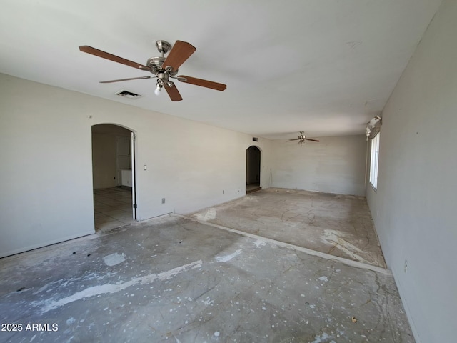 empty room featuring a ceiling fan, arched walkways, and visible vents