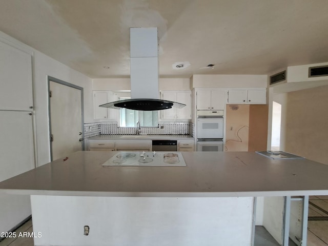 kitchen featuring white cabinets, white appliances, visible vents, and decorative backsplash