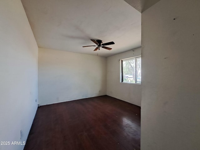 empty room featuring a ceiling fan and wood finished floors