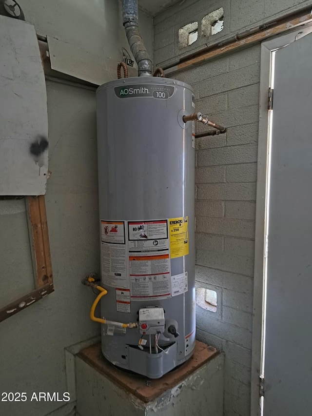 utility room featuring water heater