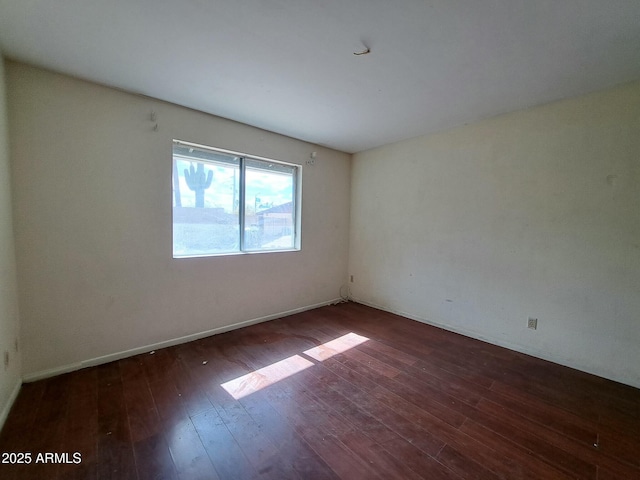 unfurnished room with wood finished floors