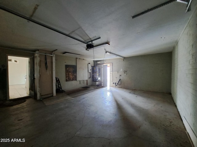 garage featuring water heater and a garage door opener