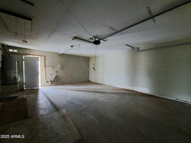 garage featuring water heater and a garage door opener